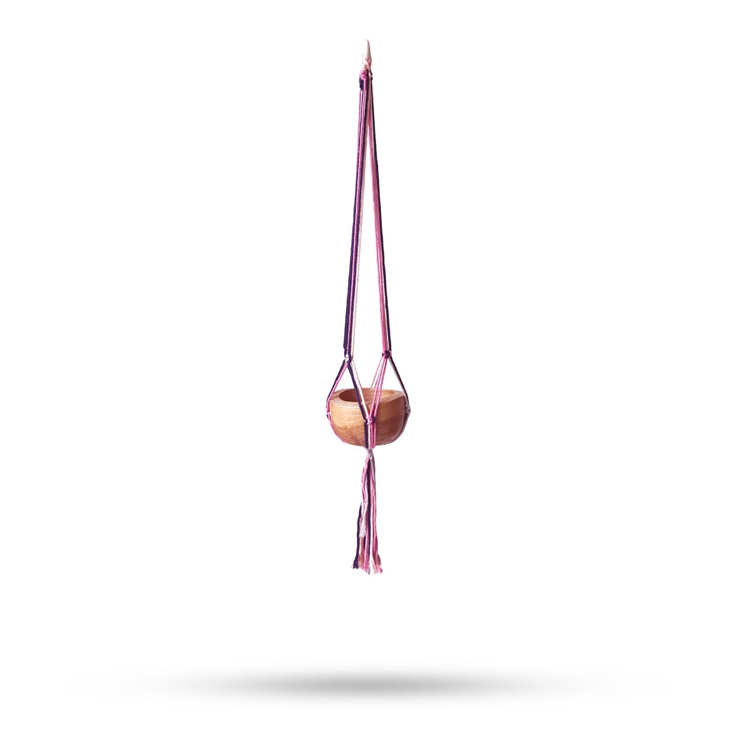 Handcrafted macrame plant hanger featuring intricate knot patterns in soft pastel cotton cord for indoor pots.
