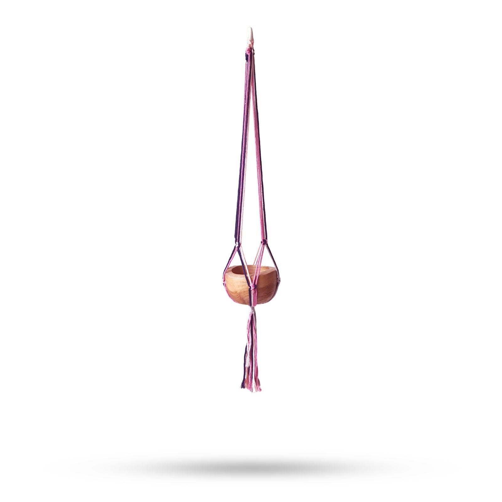 Handcrafted macrame plant hanger featuring intricate knot patterns in soft pastel cotton cord for indoor pots.