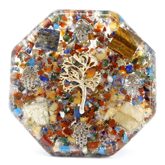 Large pyramid-shaped orgonite paperweight with a tree of life symbol, gemstone chips, and copper shavings.