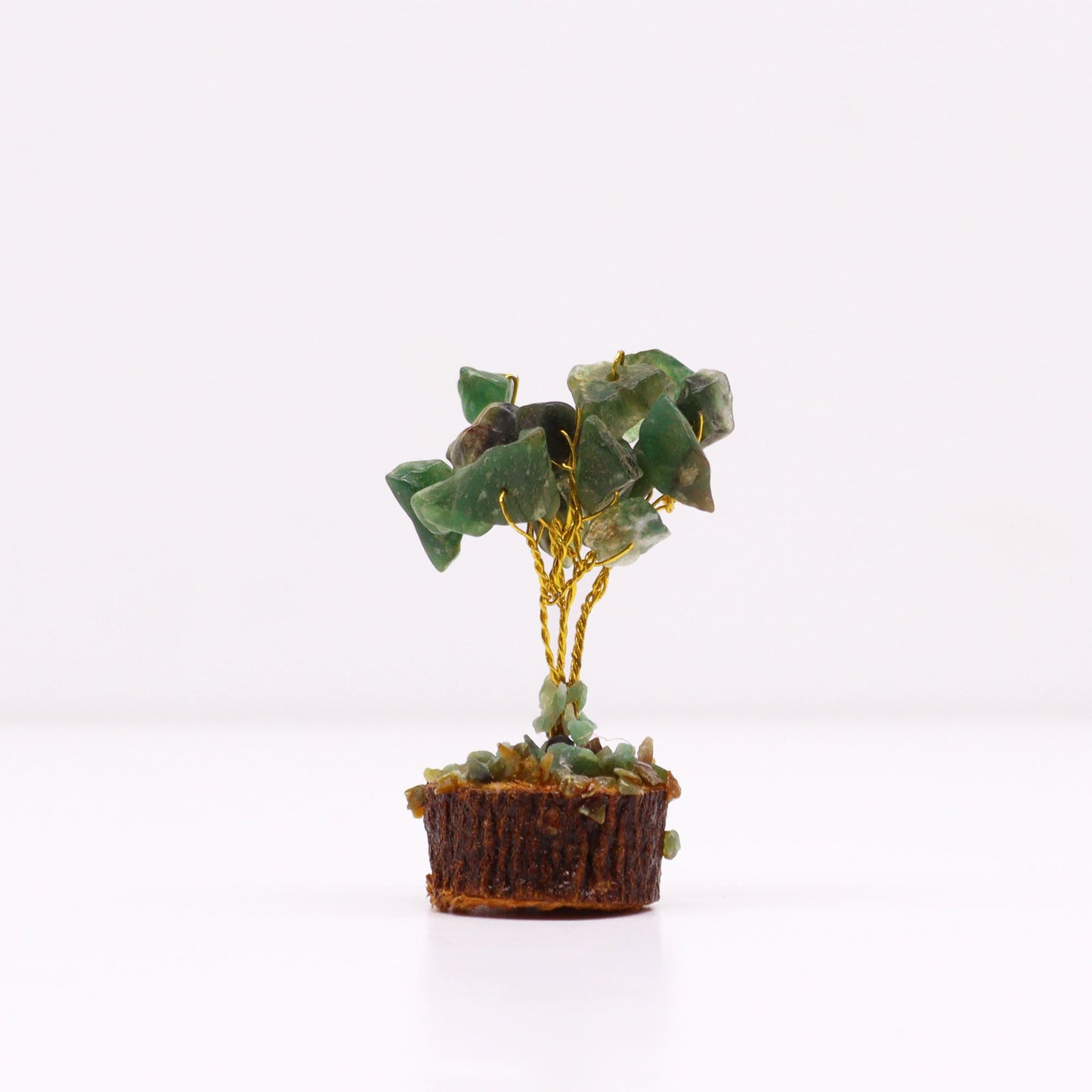 Handcrafted mini gemstone tree with green aventurine crystal leaves on a natural wood base.