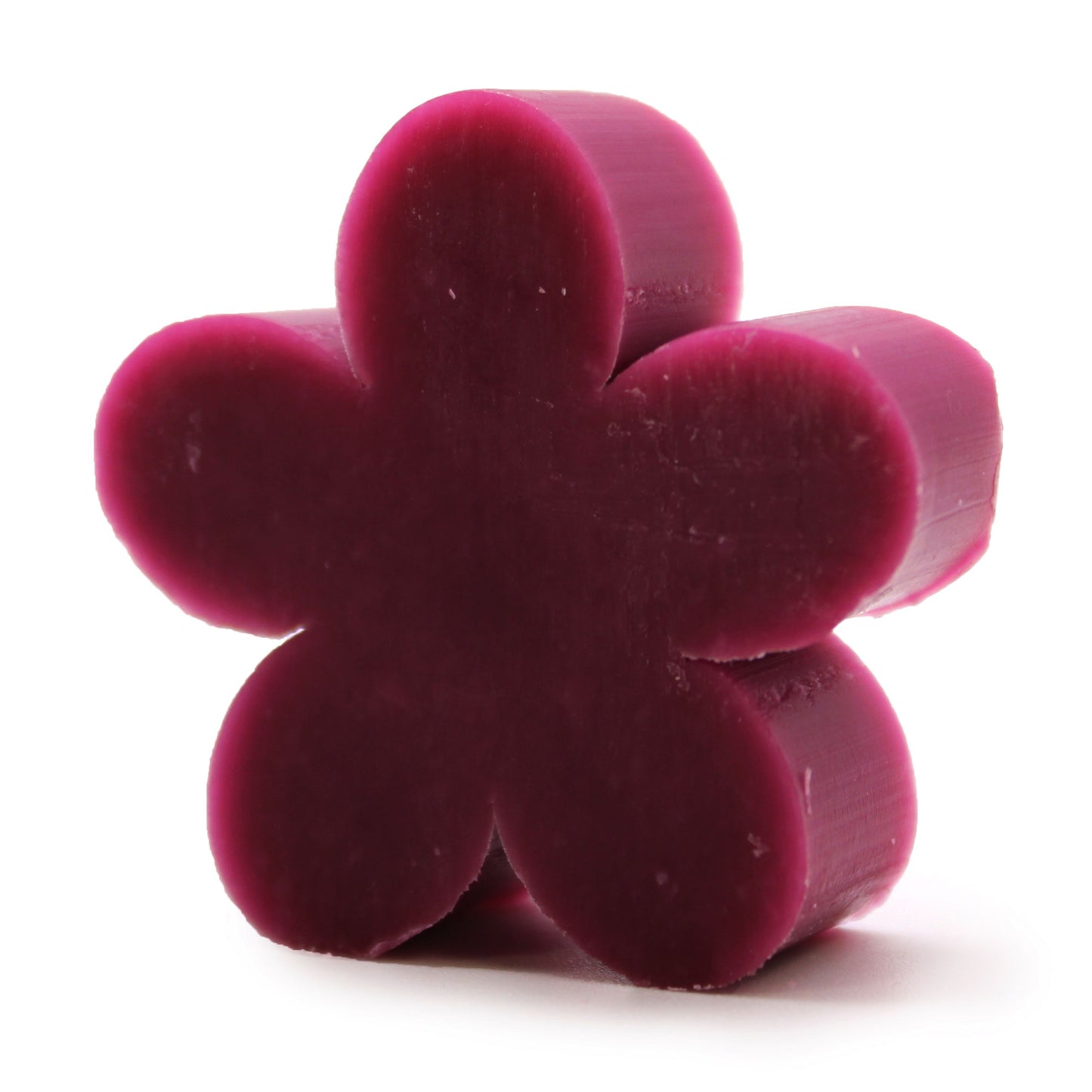 Set of ten delicate lilac-coloured soaps shaped like small flowers arranged together.