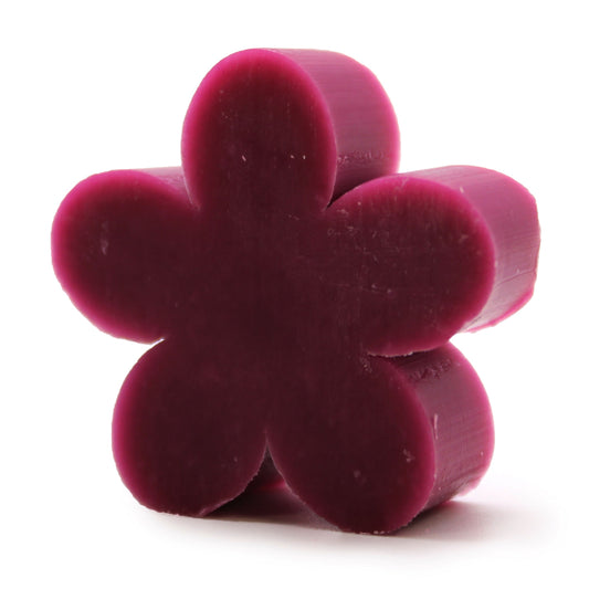 Set of ten delicate lilac-coloured soaps shaped like small flowers arranged together.