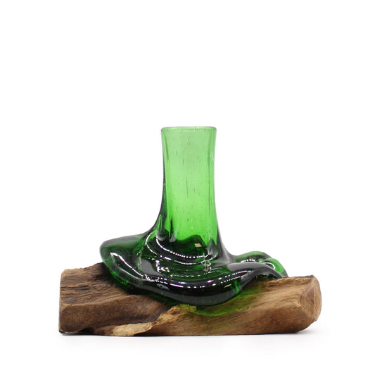Unique molten green glass vase made from a recycled beer bottle resting on a natural wood base.