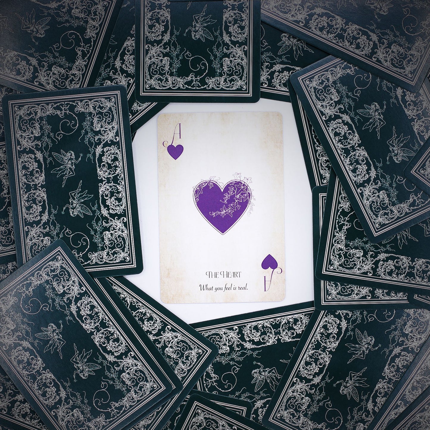 Intricate fairy-themed playing and oracle cards with aged, ethereal tones and mystical illustrations.