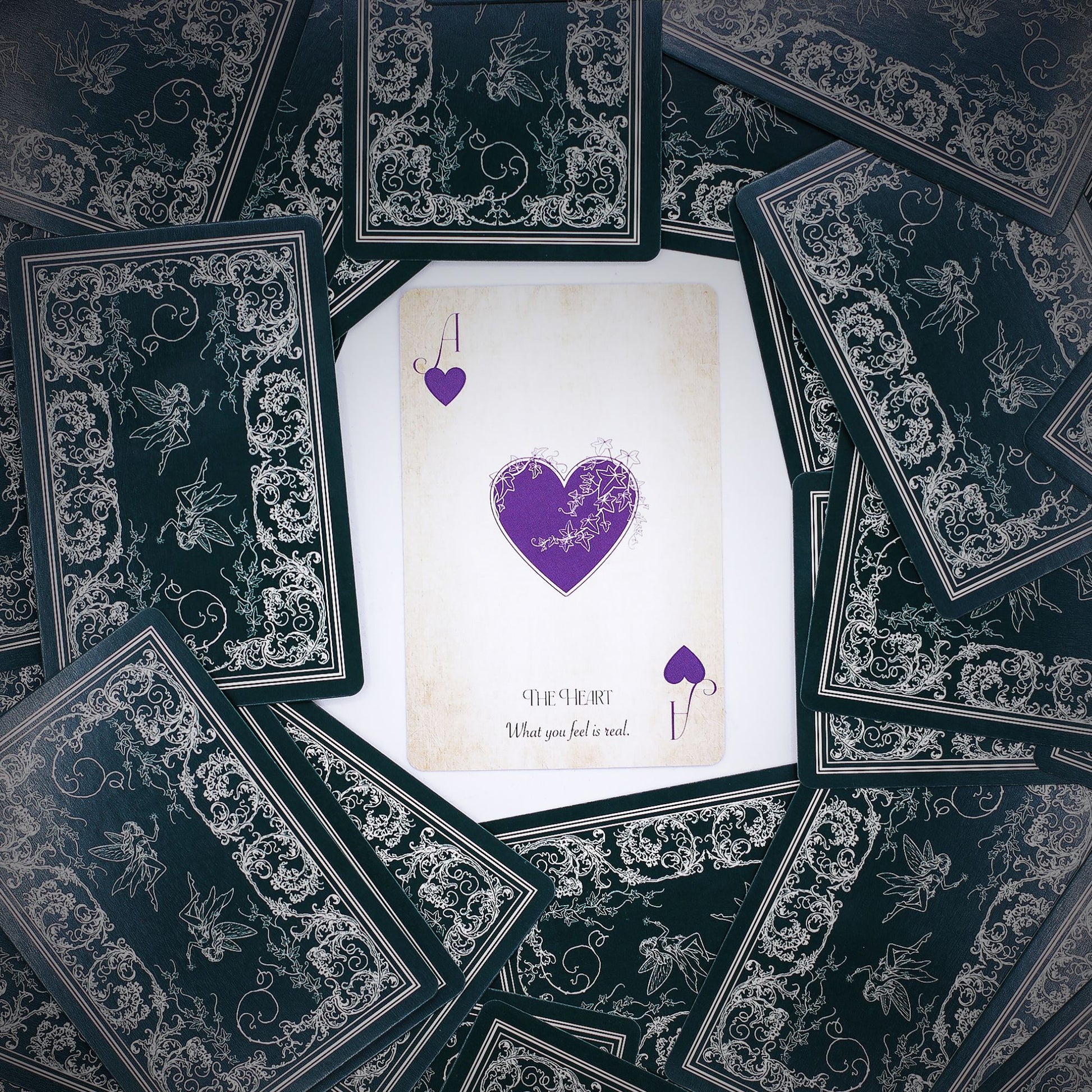 Intricate fairy-themed playing and oracle cards with aged, ethereal tones and mystical illustrations.