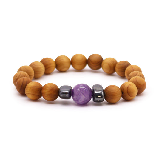 Handcrafted cedarwood bangle featuring purple amethyst beads, designed for third eye chakra spiritual alignment.