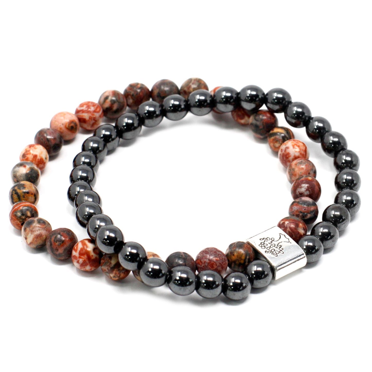 Close up of a leopard skin jasper magnetic gemstone bracelet featuring speckled earth-toned beads on an elasticated cord.