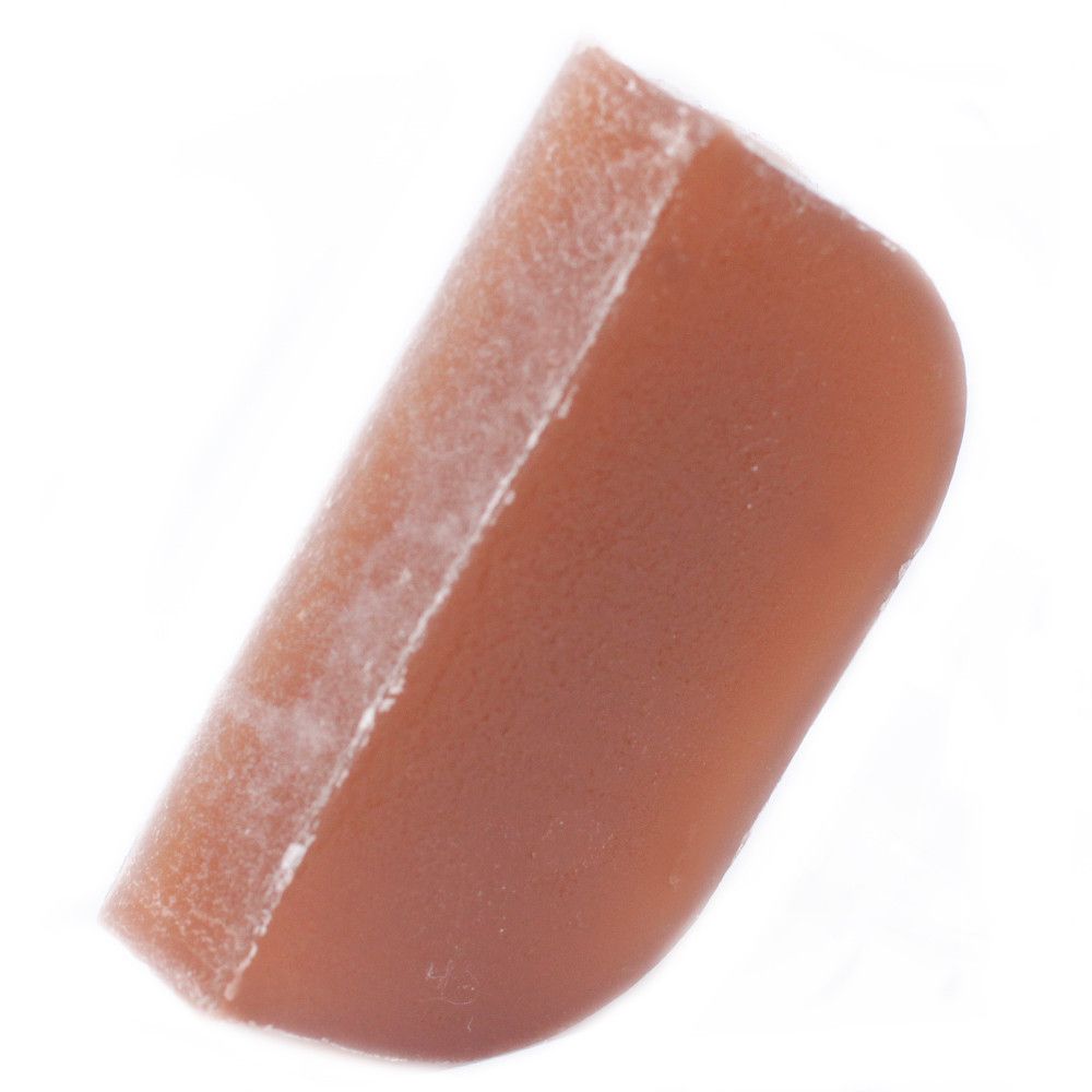 Handmade solid shampoo loaf with a textured argan oil base and spicy ginger essential oil.