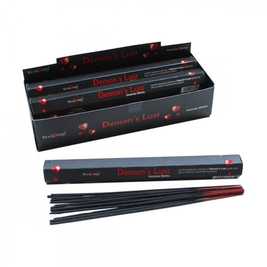 Pack of black incense sticks with mysterious dark themed packaging on a neutral background.