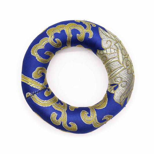 Circular blue fabric hoop cushion designed to support a medium-sized singing bowl on a flat surface.