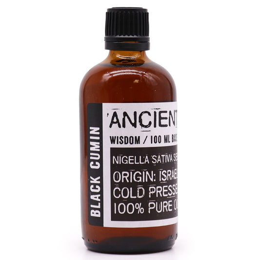 Clear bottle of dark amber-coloured black cumin seed oil on a neutral background.