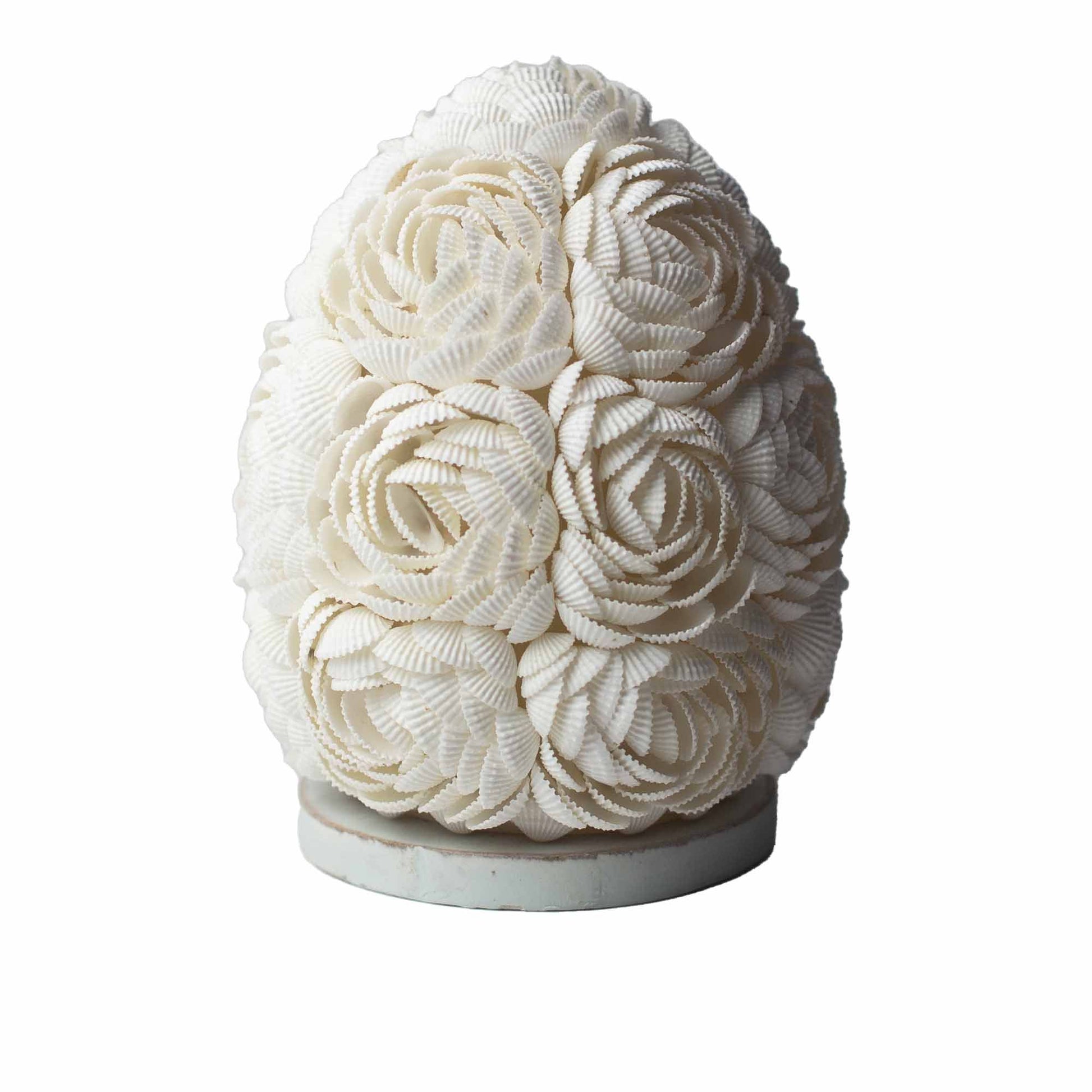 Handcrafted oval lamp made of delicate rose-tinted real seashells arranged in a decorative pattern on a white base.
