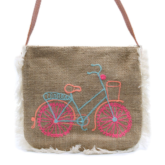 Natural jute shoulder bag featuring an embroidered bicycle design with a long brown strap and cotton fringe trim.