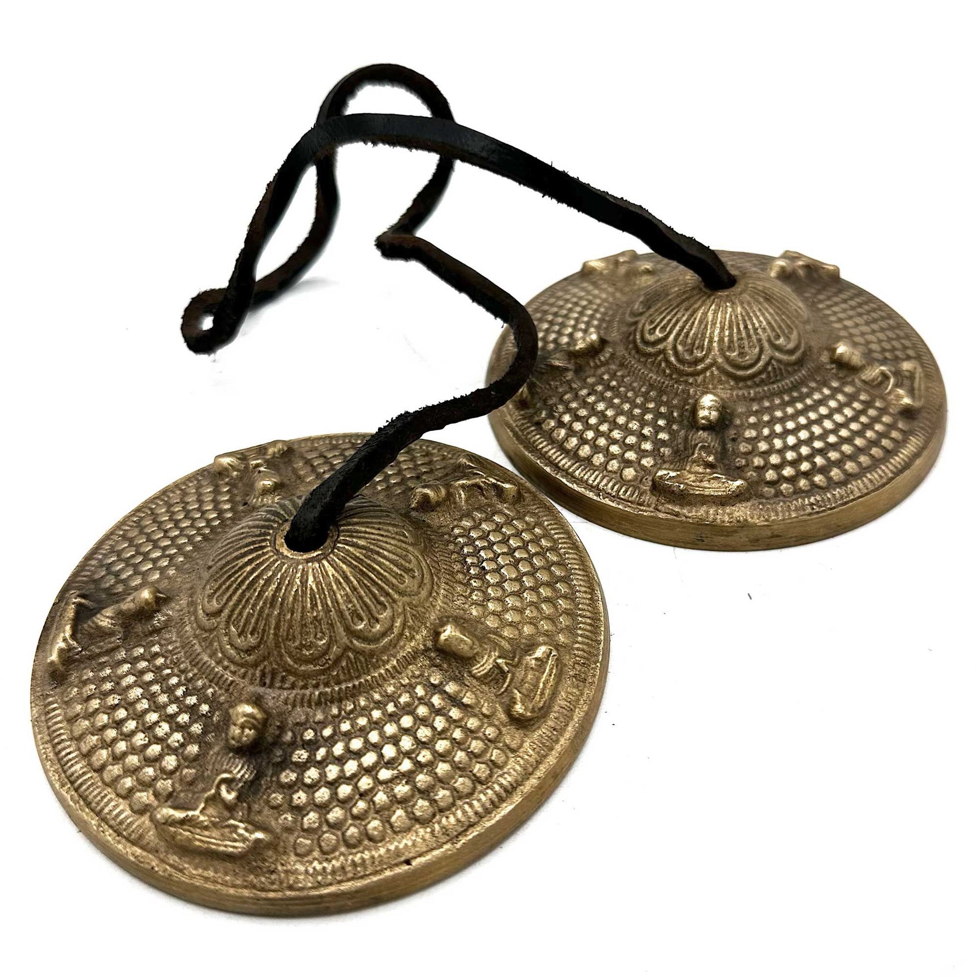 Pair of ornate Tibetan Tingsha cymbals featuring the Five Buddhas, connected by a leather strap.