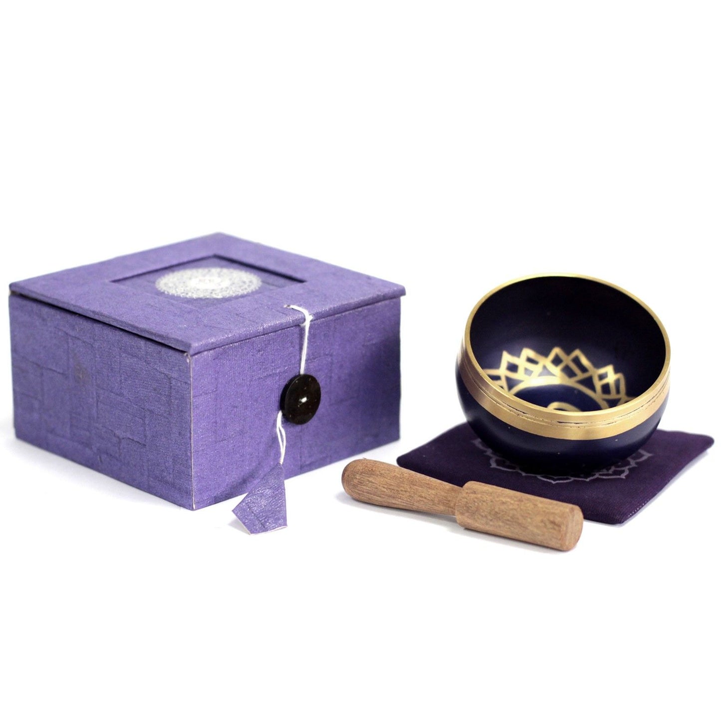 Handcrafted violet singing bowl set for Crown Chakra meditation with a wooden striker and cushion.