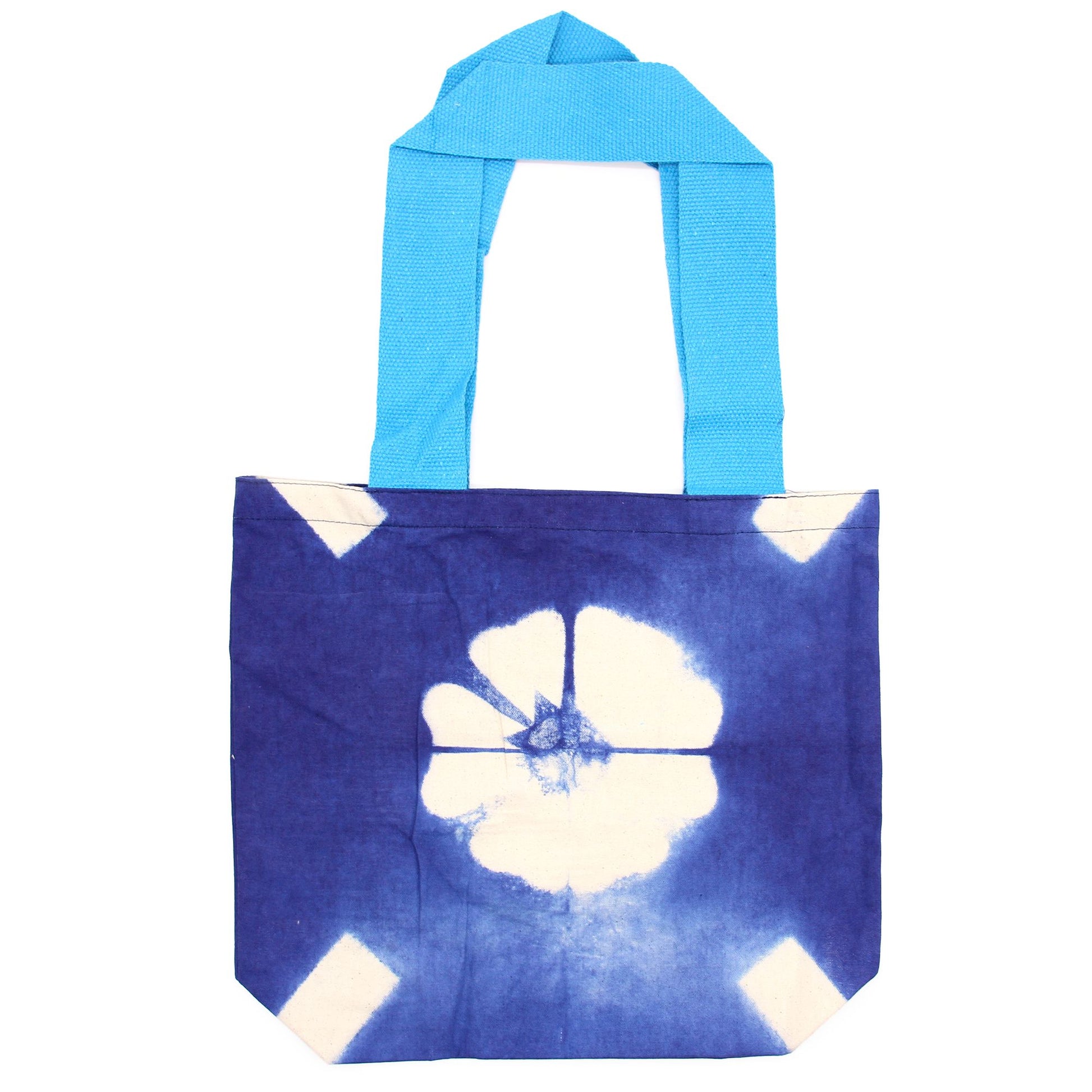 Handmade 100% natural cotton tote bag featuring a blue flower tie-dye design and matching blue handles.