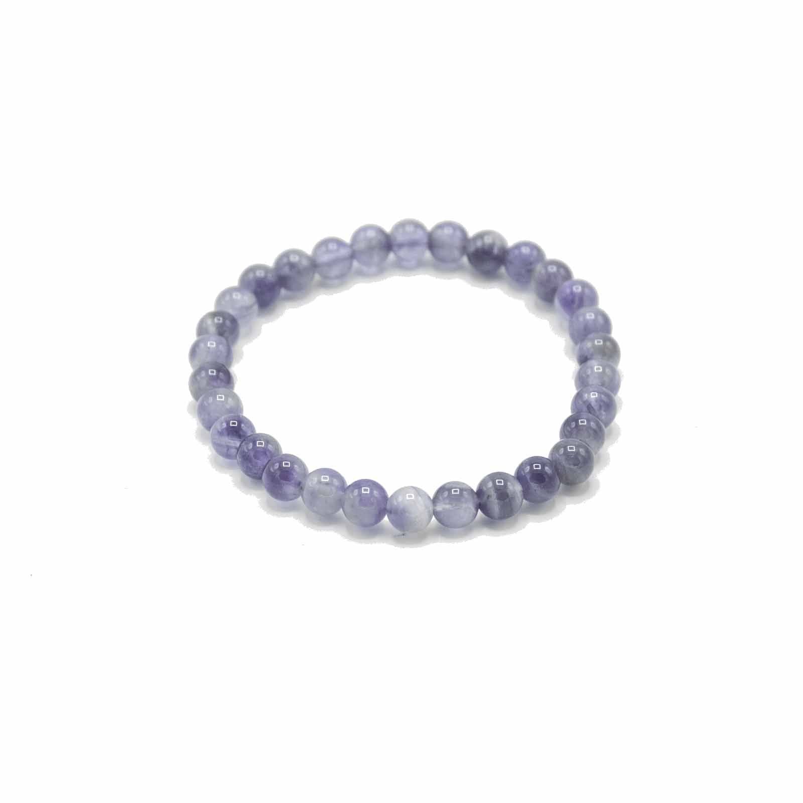 Close-up of a manifestation bracelet featuring smooth, polished purple amethyst gemstone beads on an elasticated cord.