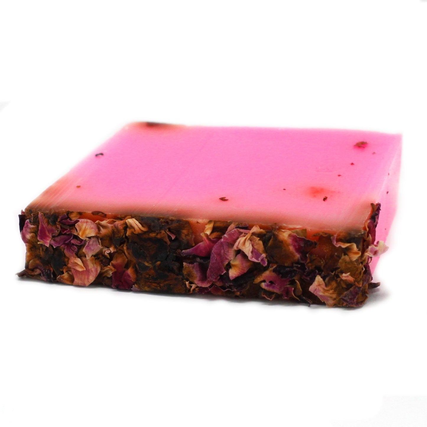 Luxurious pink soap bar topped with dried rose petals on a neutral background.