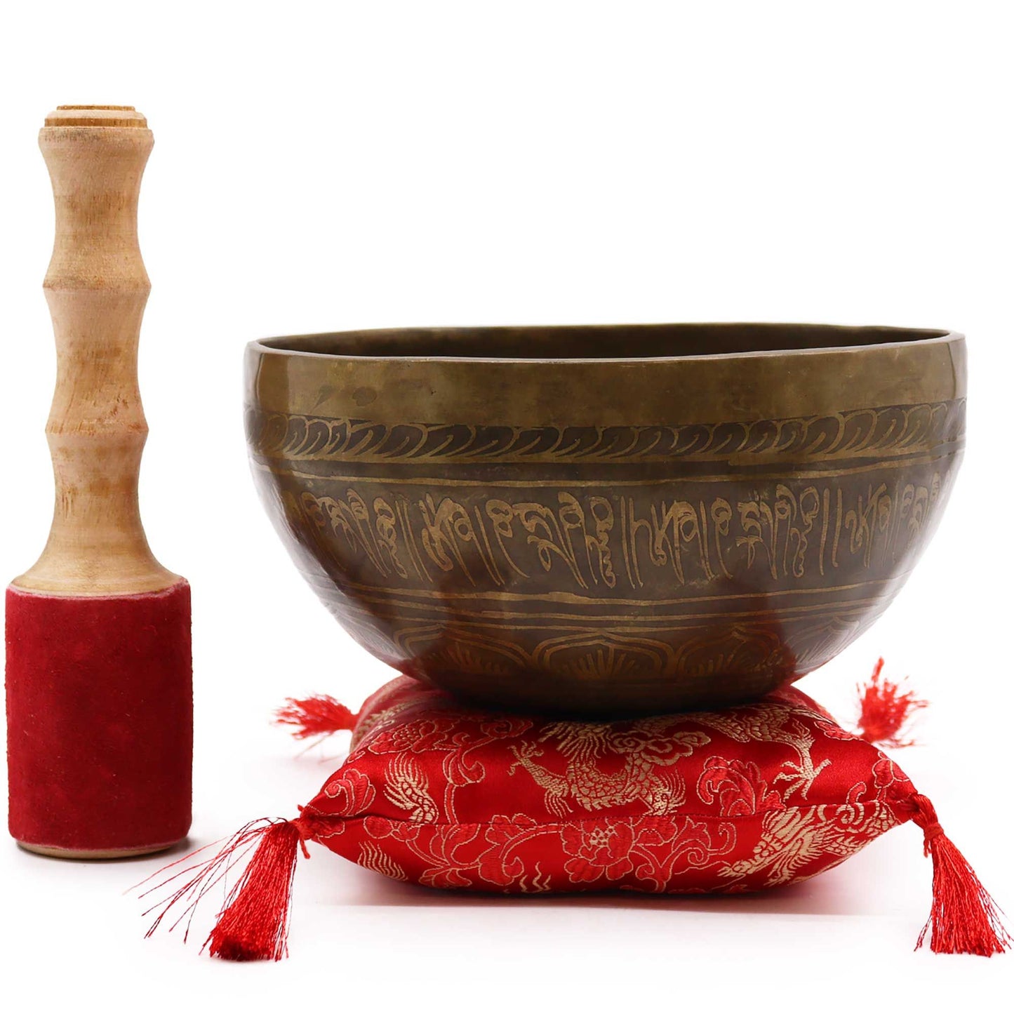 Large brass singing bowl featuring an engraved Golden Tara design, paired with a colorful cushion and suede-wrapped mallet.