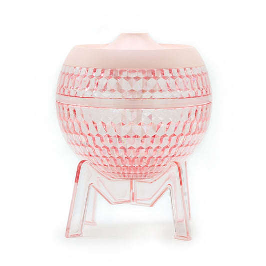 Sleek pink globe-shaped humidifier with a transparent base and soft colour-changing down light.