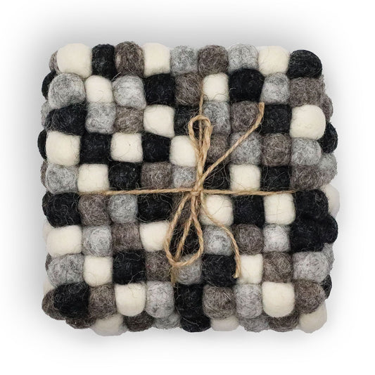 Set of four square coasters made from small felt balls in various shades of grey, arranged in a textured grid pattern.