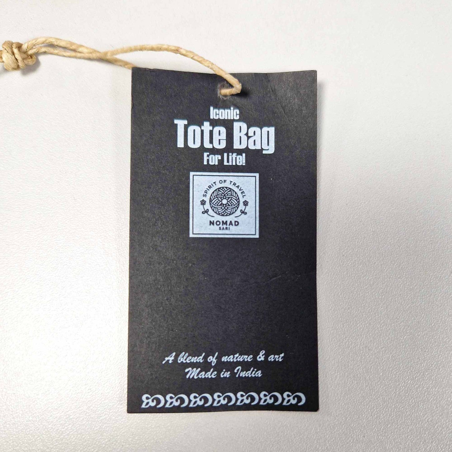 Eco-friendly natural cotton tote bag featuring a stylish Joie de Vivre typographic design in a minimalist aesthetic.