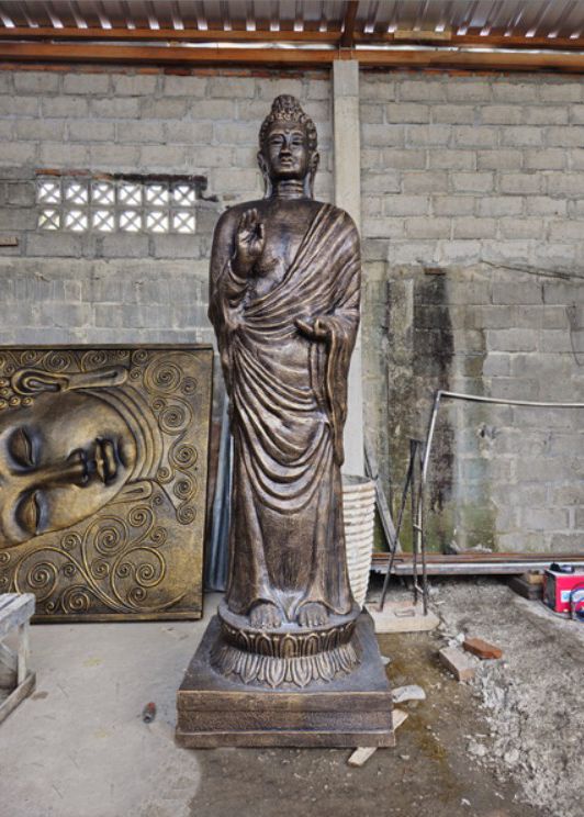 Large majestic standing Buddha statue in an antique gold finish, three metres tall with intricate handcrafted details.