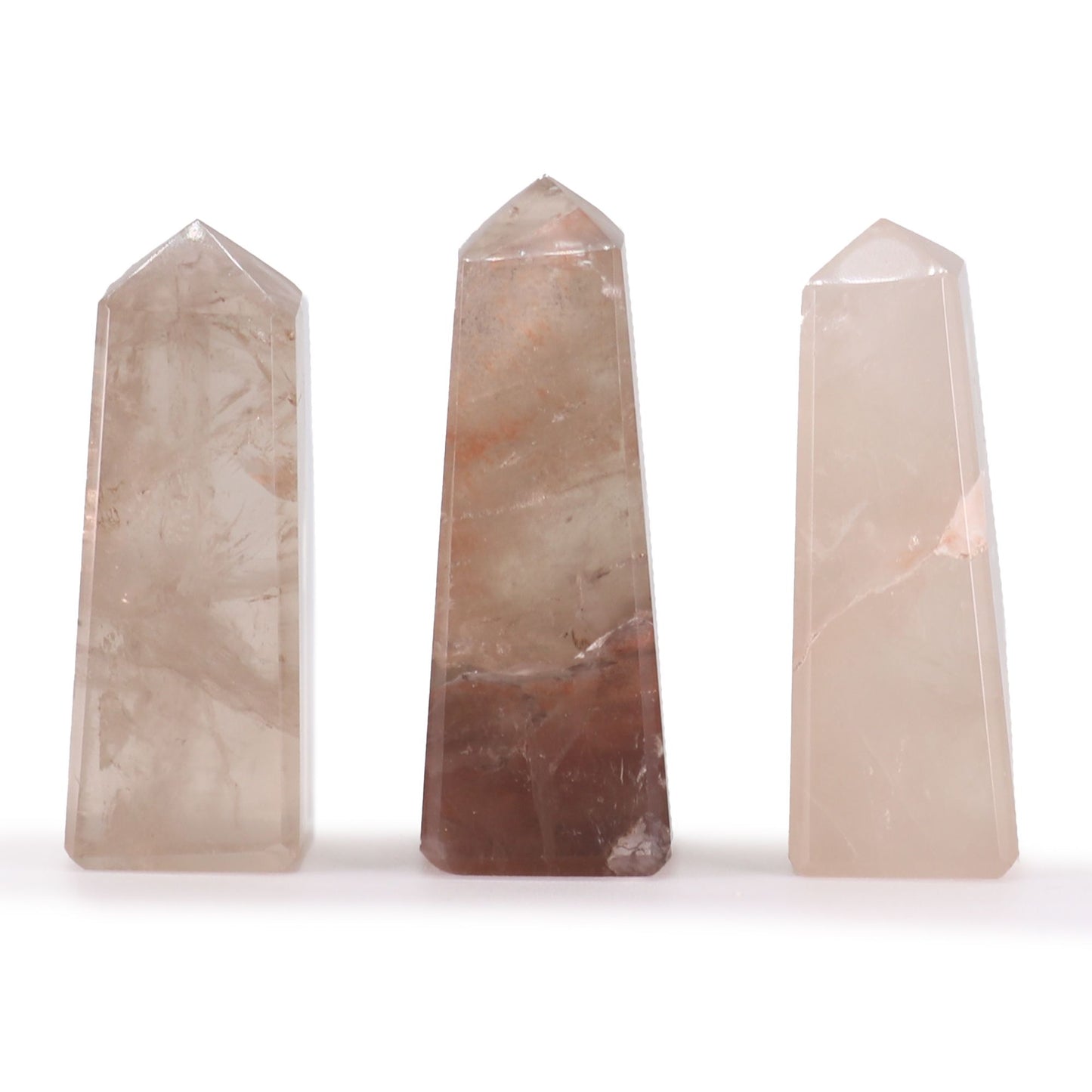 Small polished smokey quartz gemstone obelisk point with natural translucent brown hues and a sharp pointed tip.