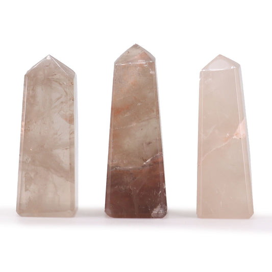 Small polished smokey quartz gemstone obelisk point with natural translucent brown hues and a sharp pointed tip.