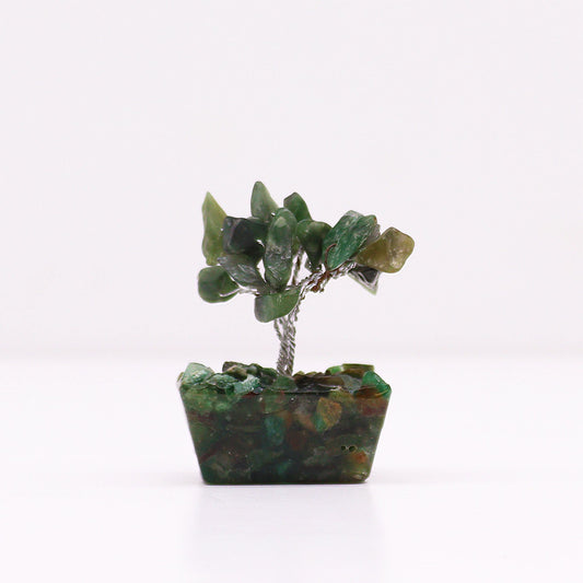 Miniature gemstone tree with green aventurine crystal leaves on a decorative orgonite pyramid base.