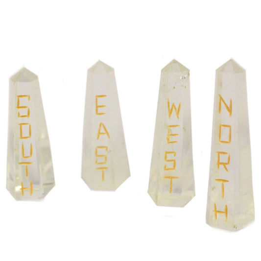 Four long natural quartz crystal points engraved with North, South, East, and West compass directions.