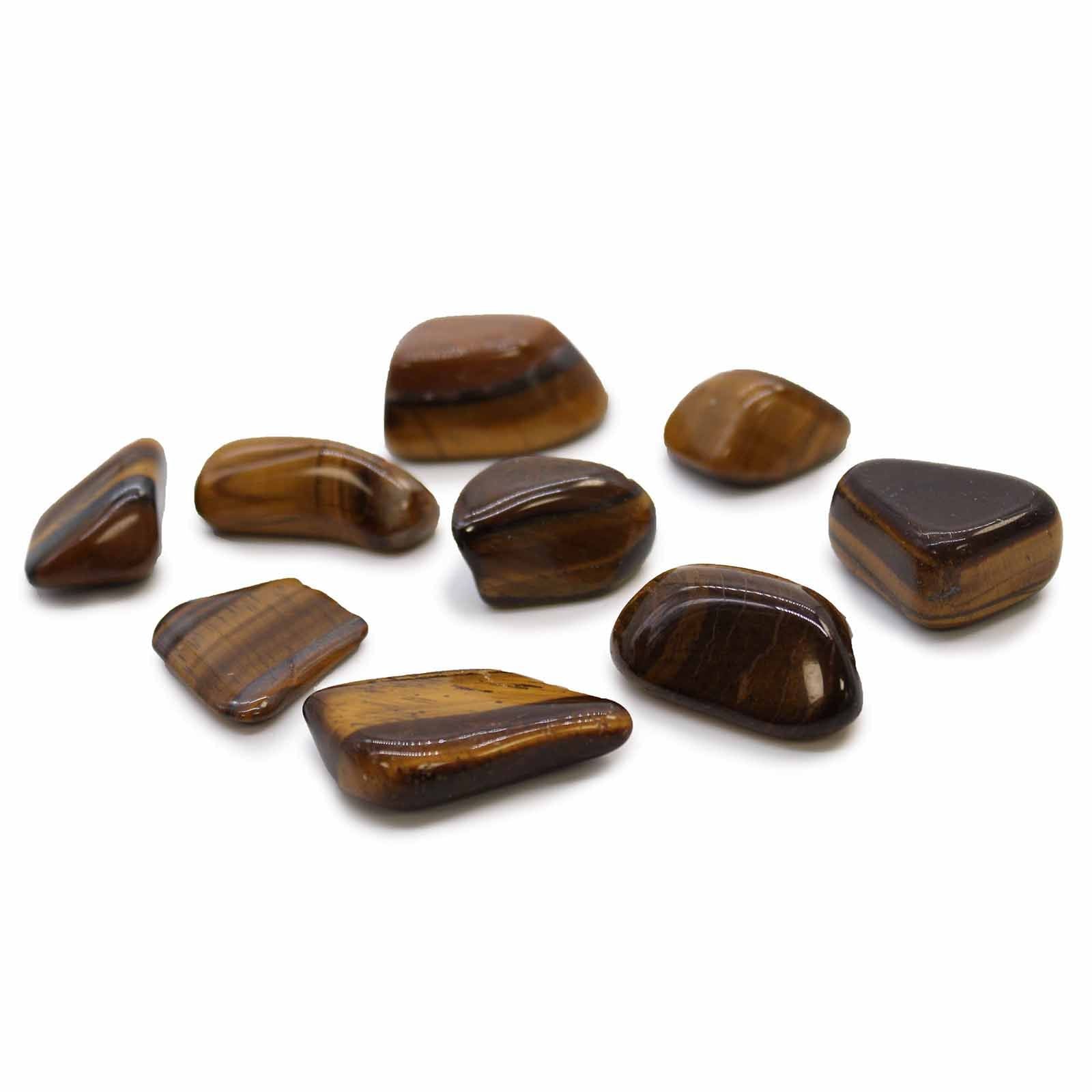 A smooth, polished golden-brown tiger eye tumble stone with characteristic chatoyant bands and a glossy finish.