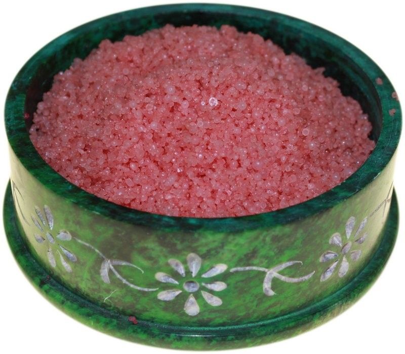 Deep red aromatic simmering granules for use in oil burners, shown in a close-up texture shot.