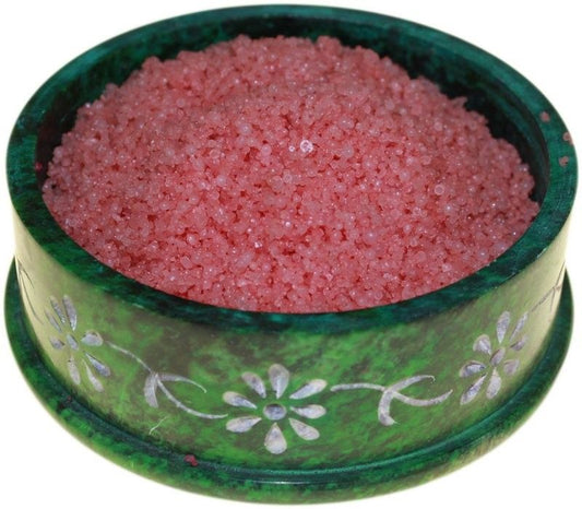 Deep red aromatic simmering granules for use in oil burners, shown in a close-up texture shot.