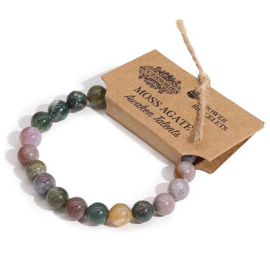 Elegant elasticated power bracelet featuring smooth, round moss agate gemstone beads with natural green inclusions.