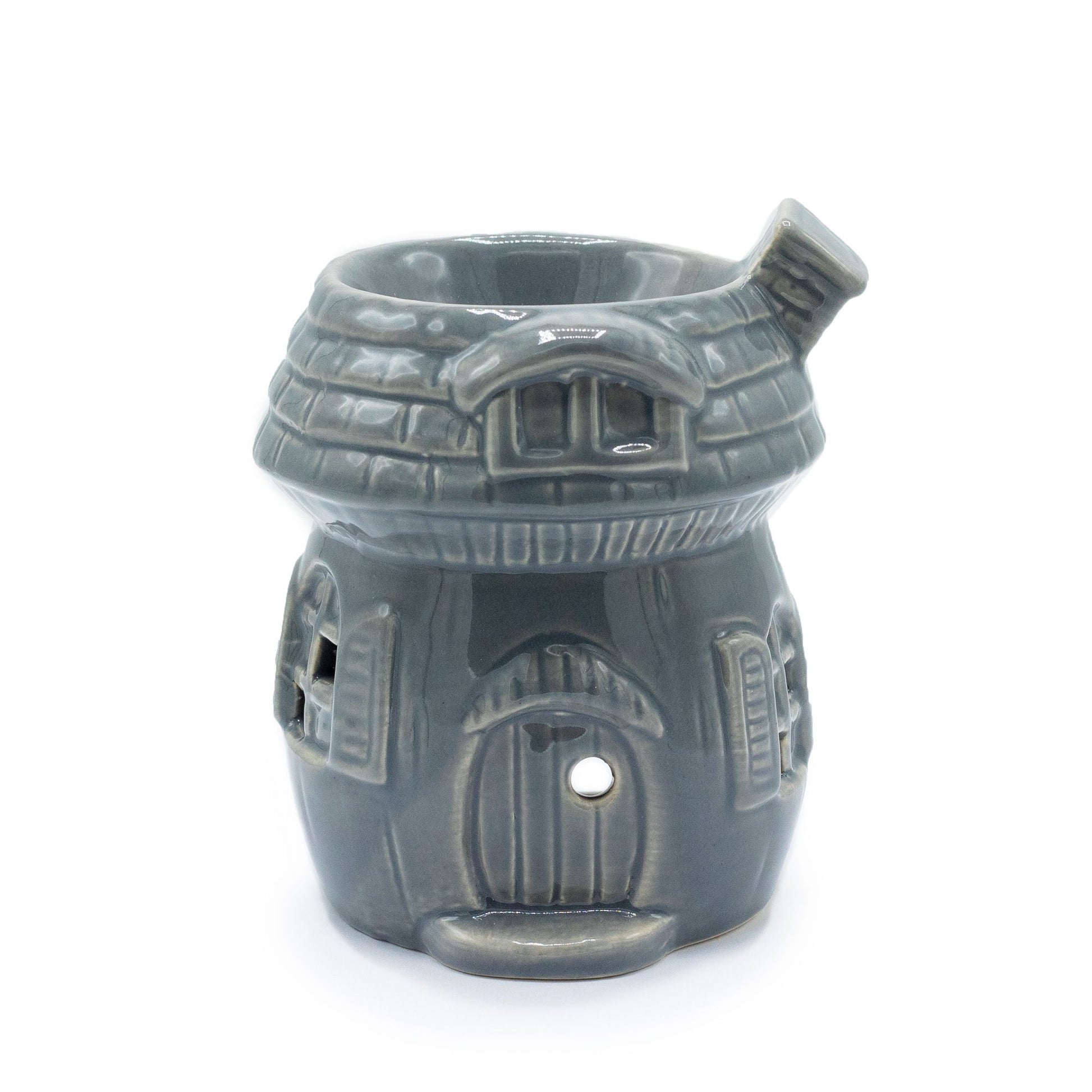 Whimsical grey ceramic oil burner shaped like a mushroom house with small window cut-outs.