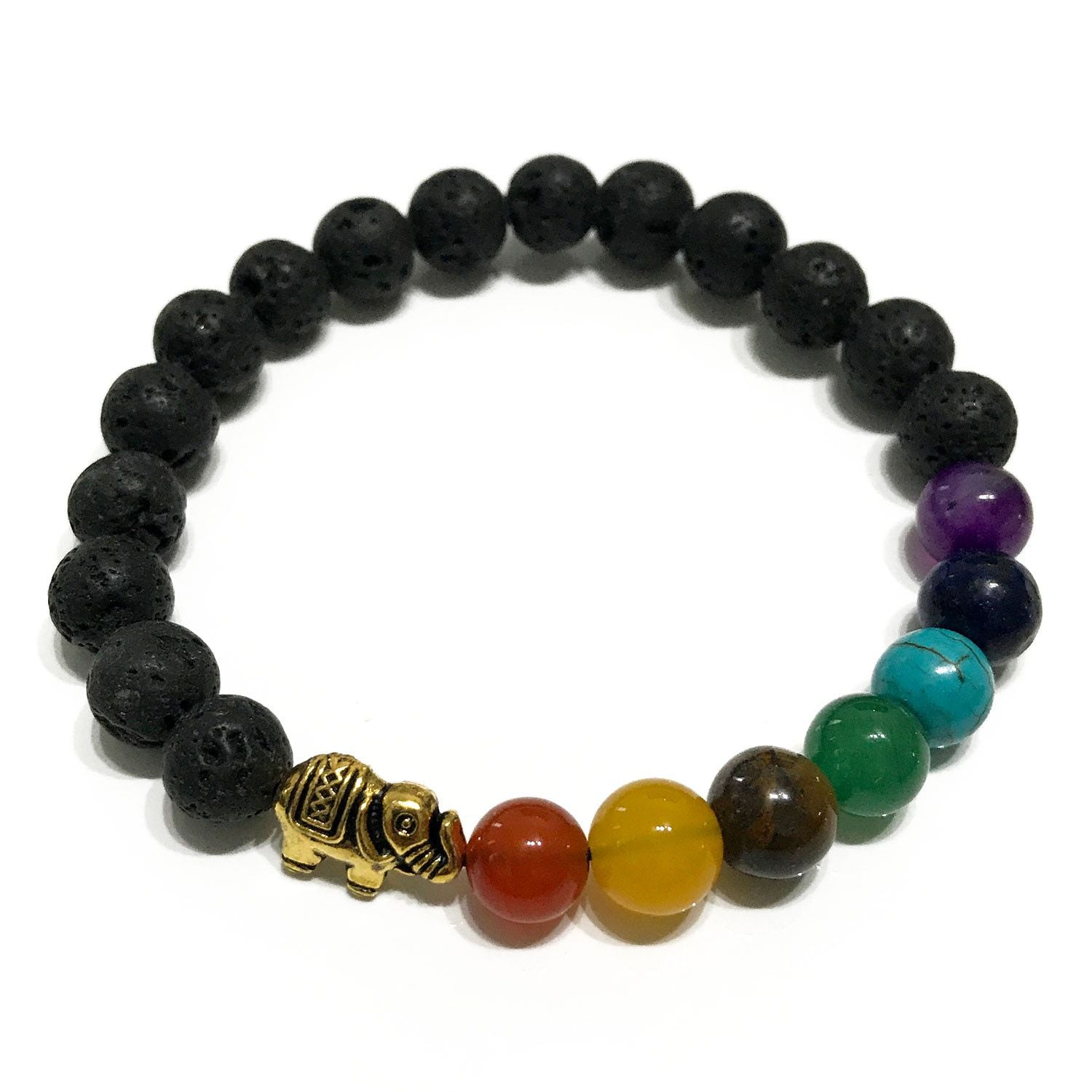 Lava stone bracelet featuring colourful chakra beads and a silver-tone elephant charm on a wooden background.
