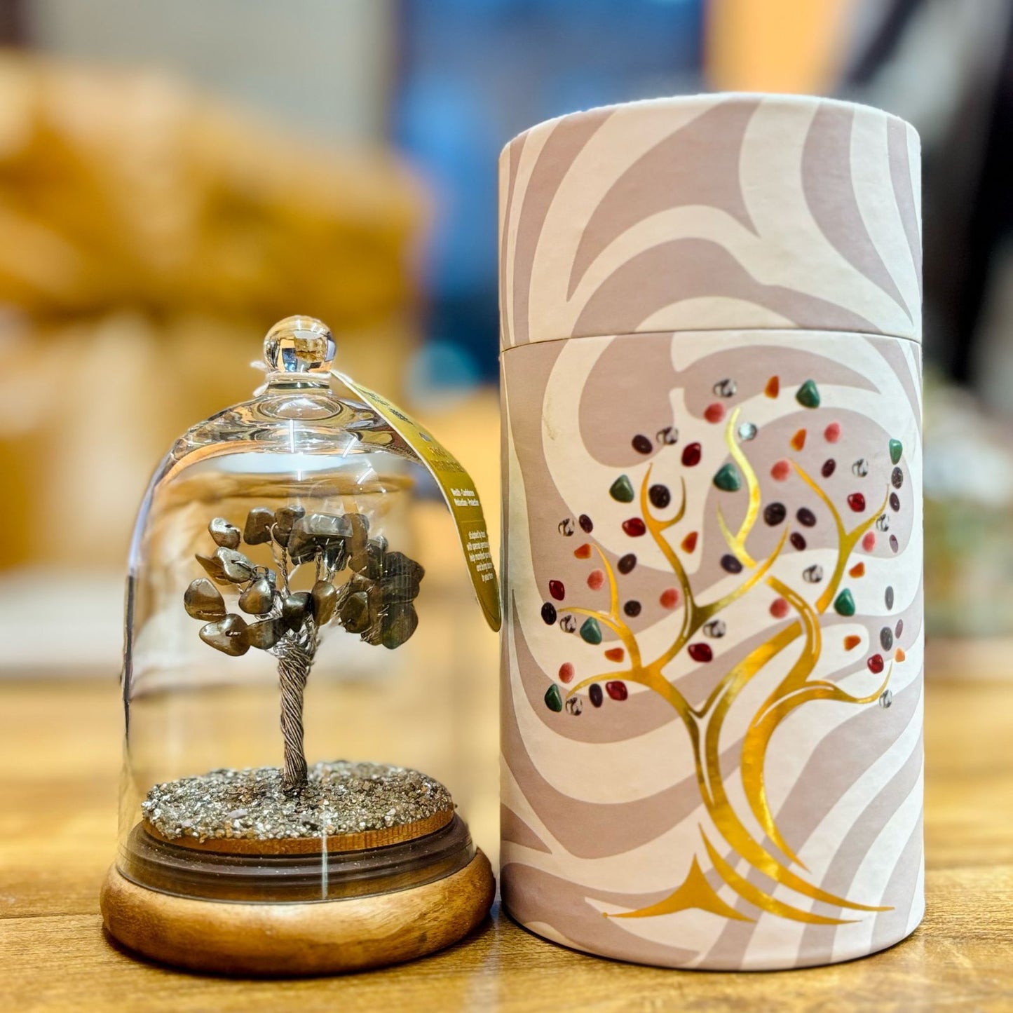 Handcrafted pyrite gemstone tree with thirty chipstones encased in a clear glass display dome.