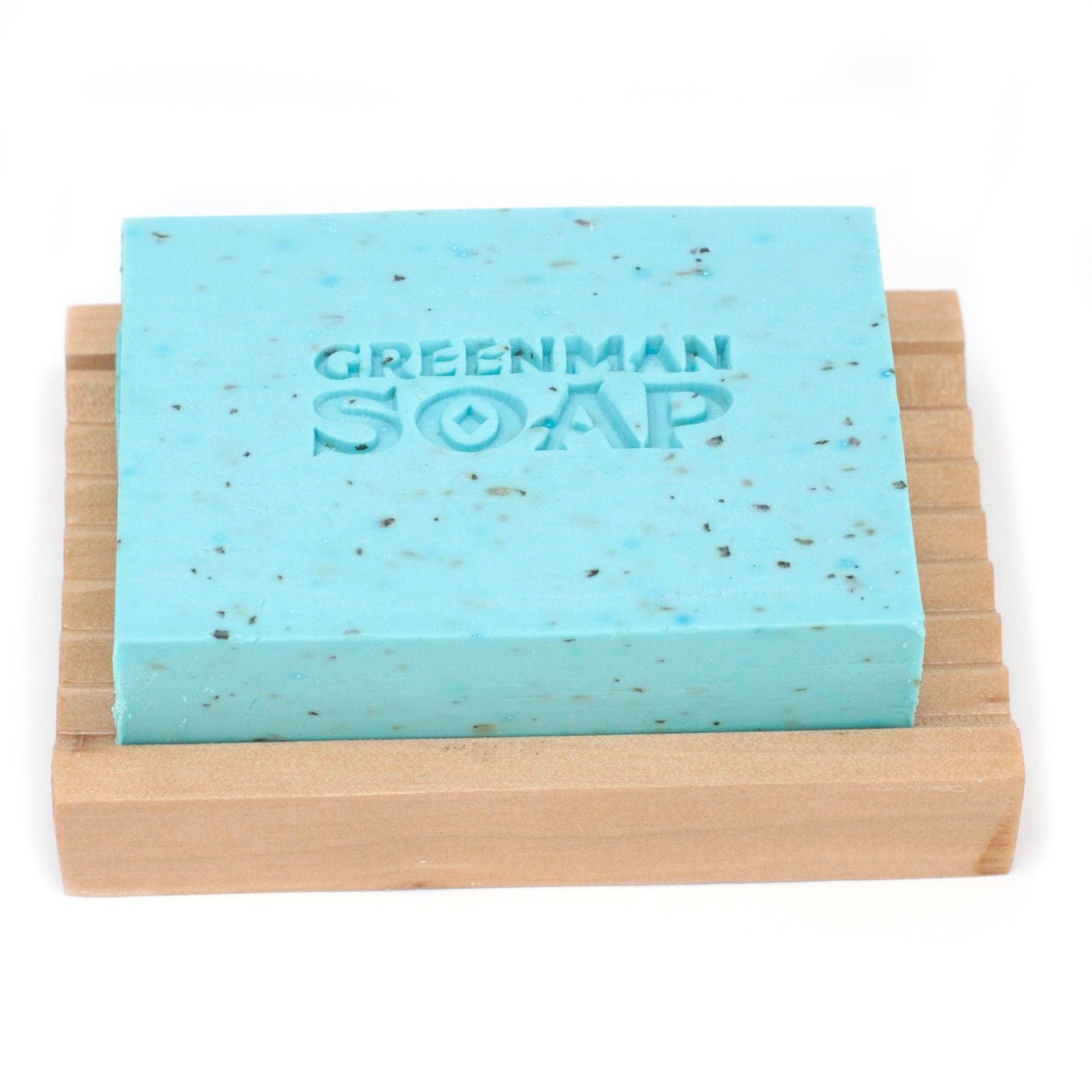 Handcrafted artisanal soap slice with dried mint leaves and a natural textured finish.