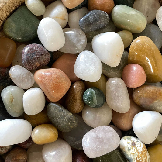 A 1kg collection of colourful polished mixed gemstone chips and small tumbled stones for decorative crafts.