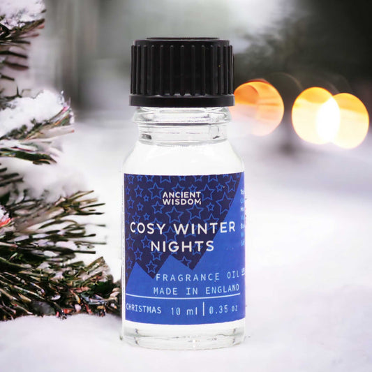 Small 10ml amber glass bottle of fragrance oil with a white and blue label featuring a winter scene.