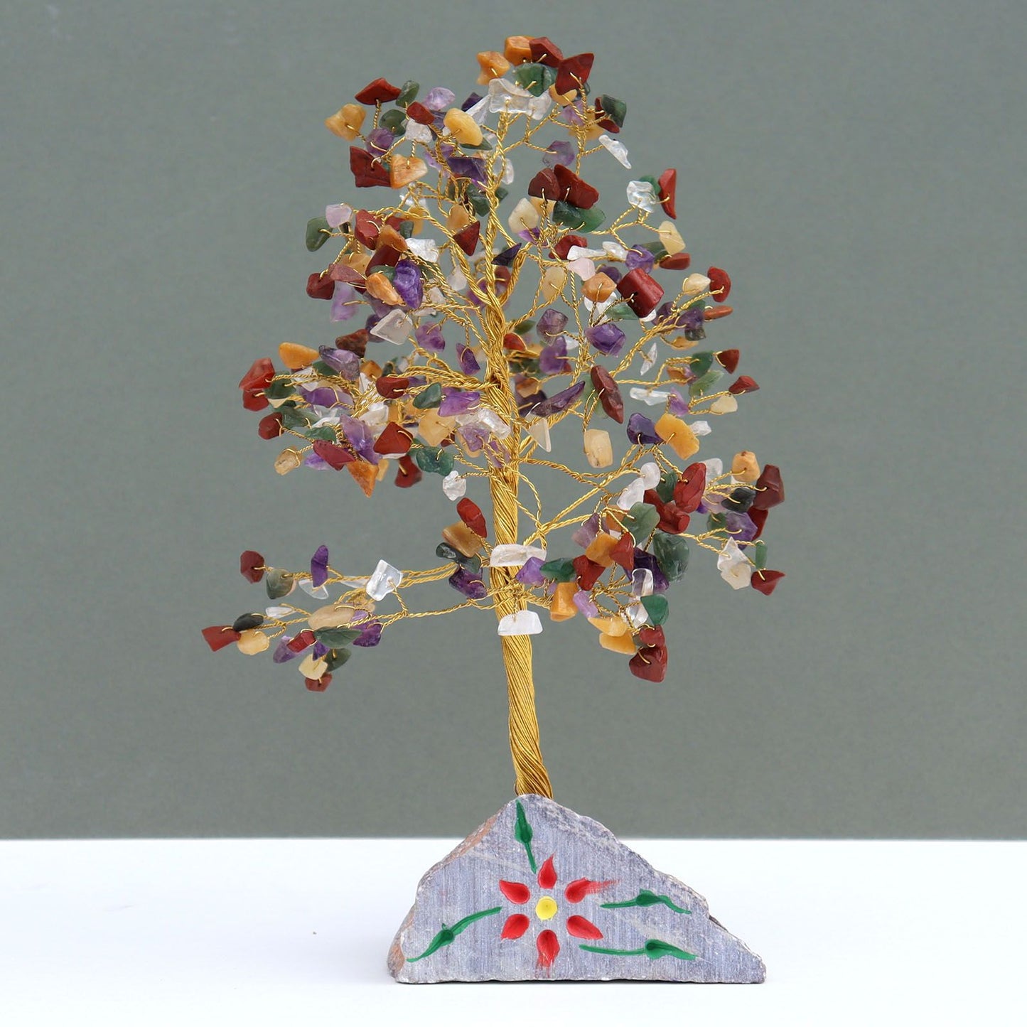 Handcrafted gemstone tree featuring 320 multi-coloured crystal stones with adjustable wire branches on a natural rock base.