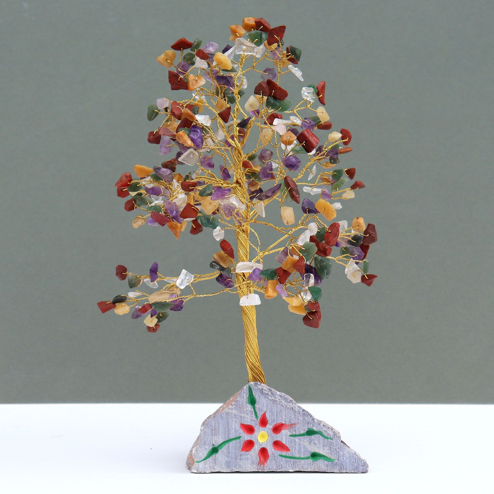 Handcrafted gemstone tree featuring 320 multi-coloured crystal stones with adjustable wire branches on a natural rock base.