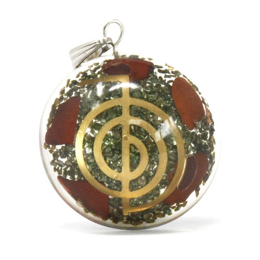 Dome shaped orgonite pendant featuring layered gemstone chips, copper filings, and a central symbolic esoteric object.