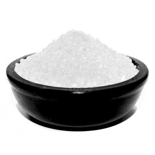 Close-up of small, fragrant white simmering granules with a crystalline texture for use in oil burners.