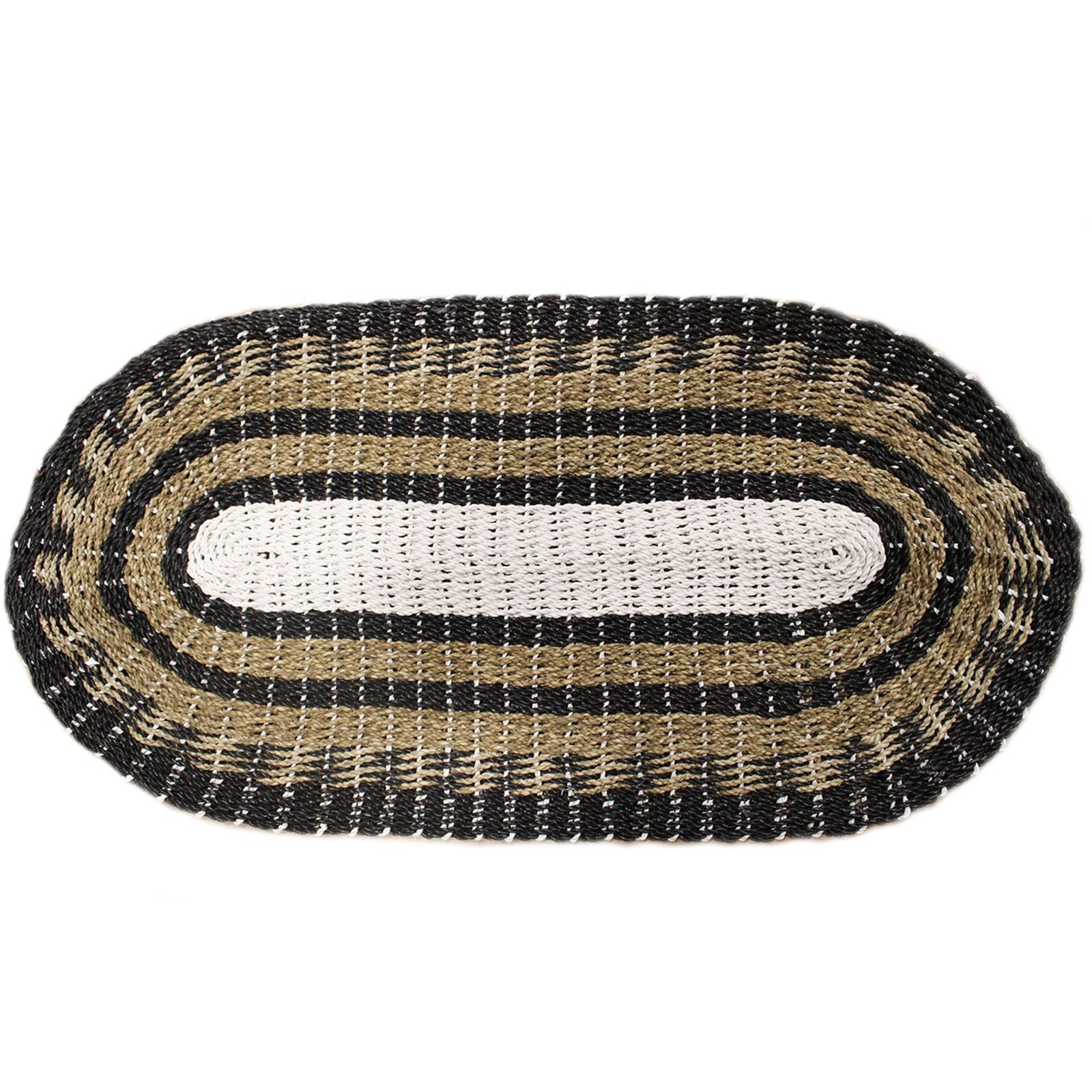 Oval seagrass rug featuring a woven pattern of black, white, and tan natural fibres.