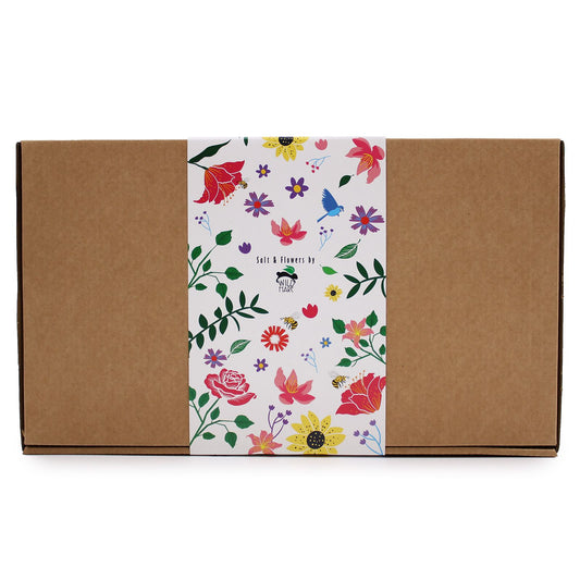 Elegant gift box containing a glass jar of herbal bath salts and eight delicate pink soap roses.