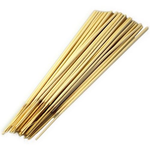 Large bundle of ivory-coloured unfragranced raw incense sticks on bamboo stems.