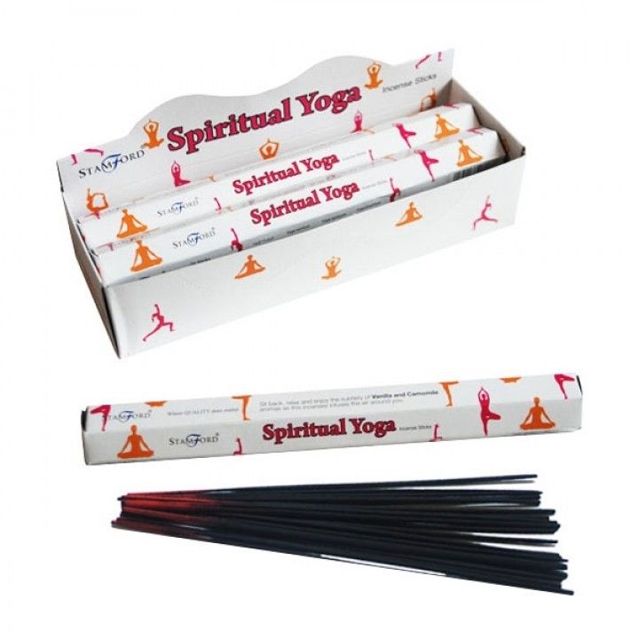 Hexagonal box of premium spiritual yoga incense sticks next to a burning stick releasing a gentle plume of fragrant smoke.
