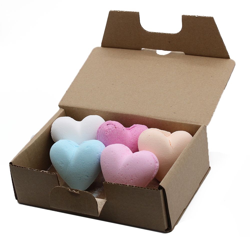 A collection of six colourful heart-shaped bath bombs arranged in a gift box.